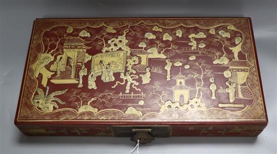 A Chinese red lacquer box, gilded with figures and landscape, width 38cm